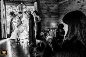 At an Airbnb in Plymouth, Massachusetts, USA, layers of lace and hands on deck capture the real-life wedding prep, with a baby being fed in the corner, all in beautiful, messy harmony.